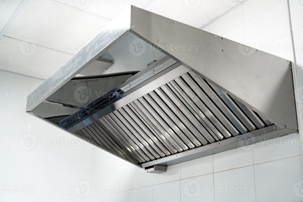 stainless steel kitchen exhaust hood in modern restaurant kitchen for effective ventilation and smoke removal photo